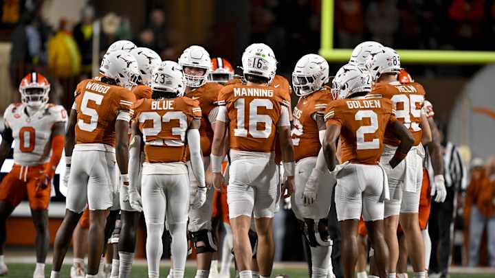 Coach Steve Sarkisian and quarterback Arch Manning of the Texas Longhorns in discussion during a game, emphasizing trust, growth, and legacy.